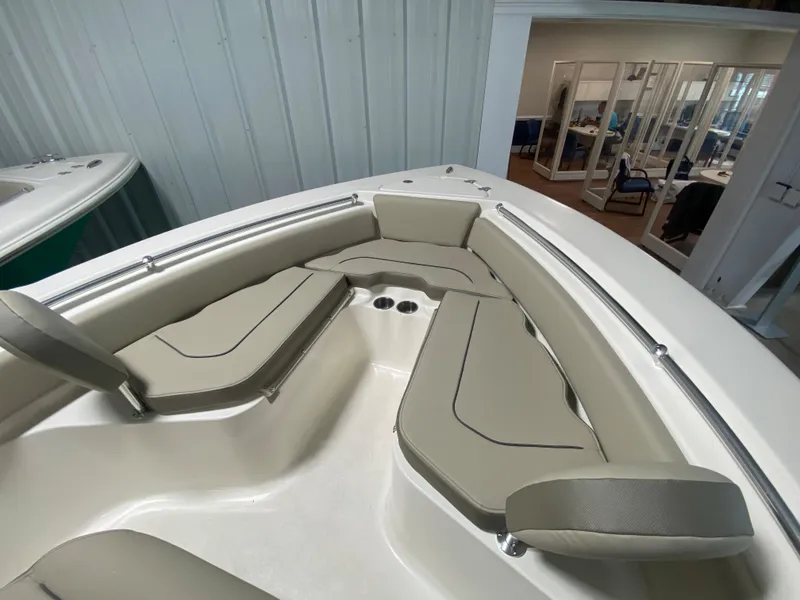 Slide: The Image of 2024 Key West 219 FS boat interior with cushioned seating and cup holders. - 16
