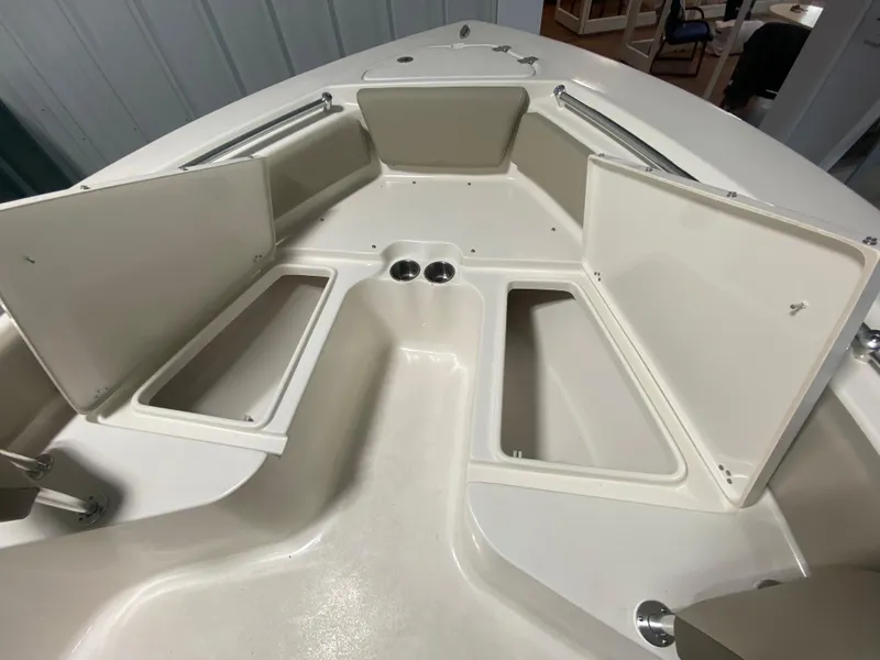 Slide: The Image of 2024 Key West 219 FS boat with open storage compartments. - 19