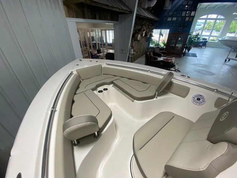 Slide: The Image of 2024 Key West 219 FS boat interior with cushioned seating and cup holders. - 8