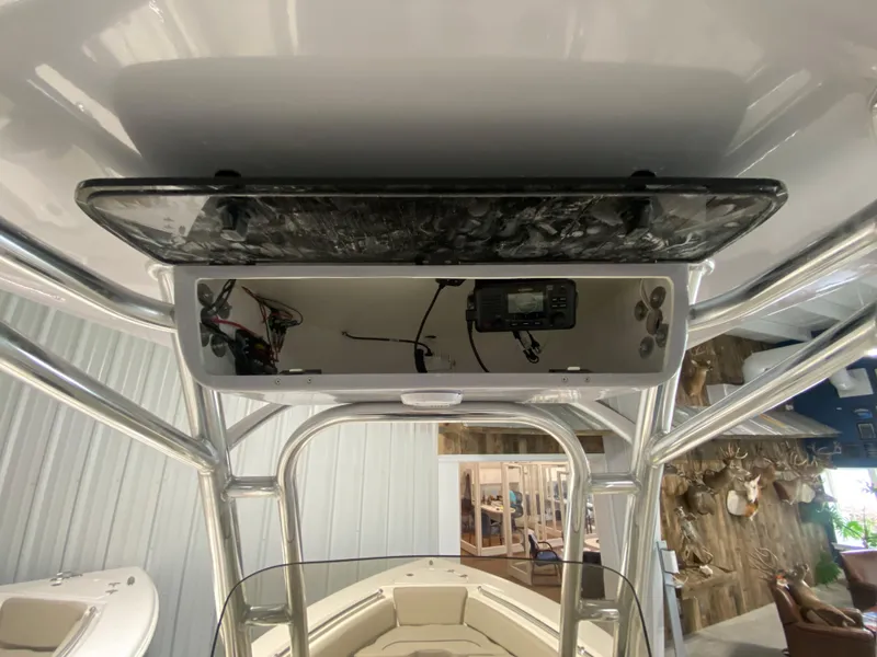 Slide: The Image of 2024 Key West 219 FS boat console with electronics and storage compartment. - 9