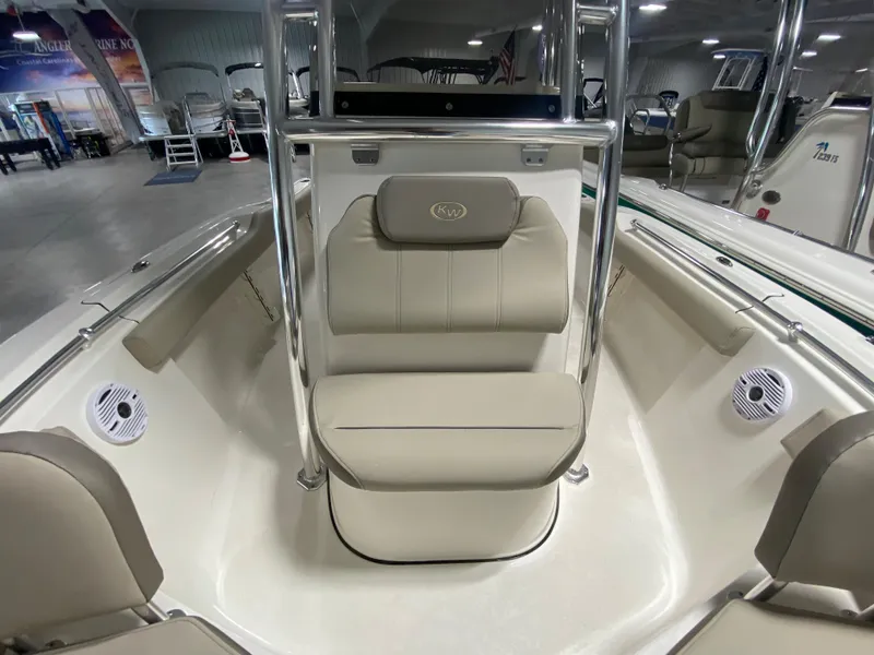 Slide: The Image of 2024 Key West 219 FS boat interior with cushioned seating and speakers. - 17