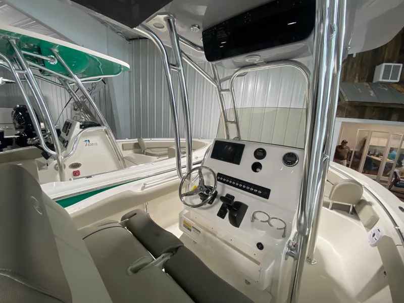 Slide: The Image of 2024 Key West 219 FS boat interior with steering console and seating. - 6