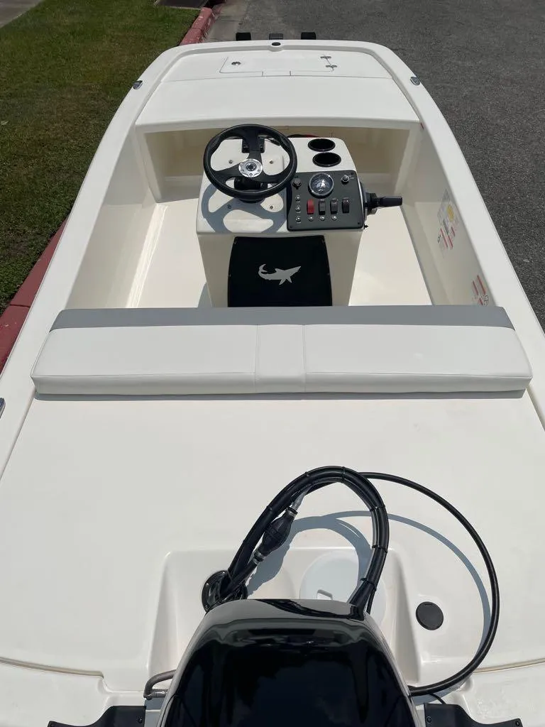 Slide: The Image of 2023 Mako Pro Skiff 13 CC boat interior with steering console and seating. - 2