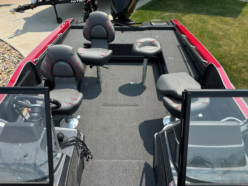 Slide: The Image of 2023 Nitro ZV20 Pro fishing boat interior with four seats and red accents. - 4