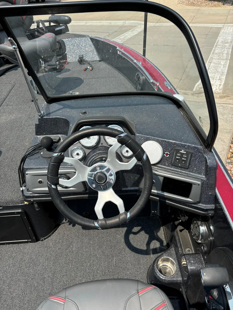Slide: The Image of 2023 Nitro ZV20 Pro boat dashboard with steering wheel and control panel. - 8