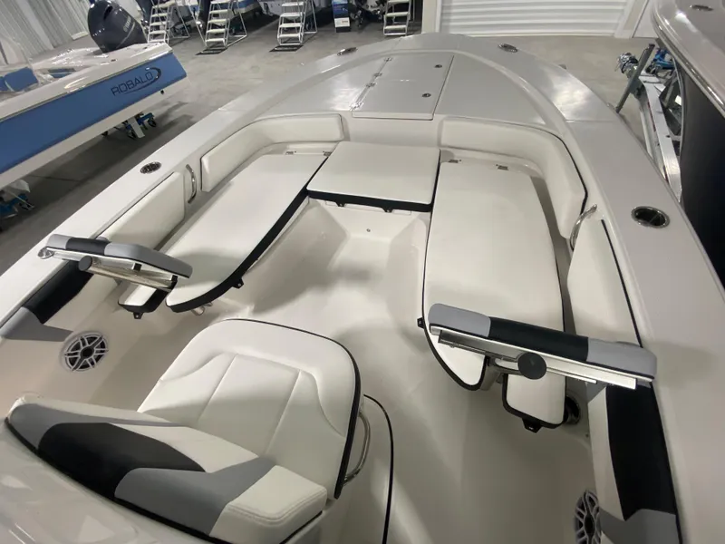 Slide: The Image of 2024 Robalo 246 Cayman boat interior with seating and storage compartments. - 12