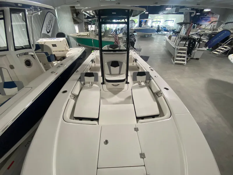 Slide: The Image of 2024 Robalo 246 Cayman center console boat in showroom. - 13