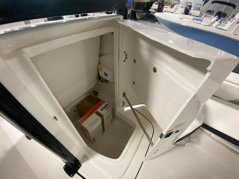 Slide: The Image of Storage compartment of 2024 Robalo 246 Cayman boat with equipment inside. - 19