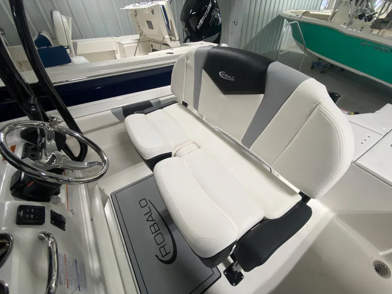 Slide: The Image of 2024 Robalo 246 Cayman boat interior with white and gray seating. - 9