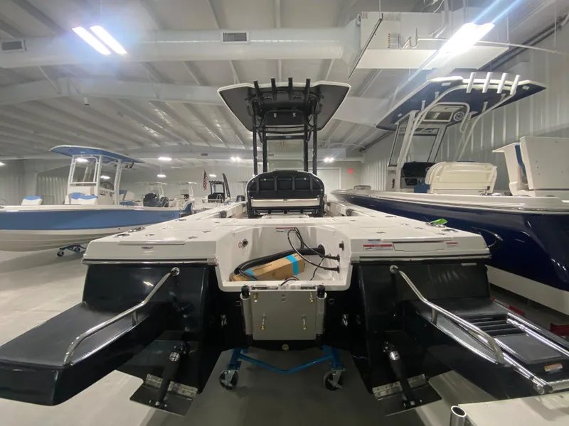 Slide: The Image of 2024 Robalo 246 Cayman boat in showroom, rear view. - 2