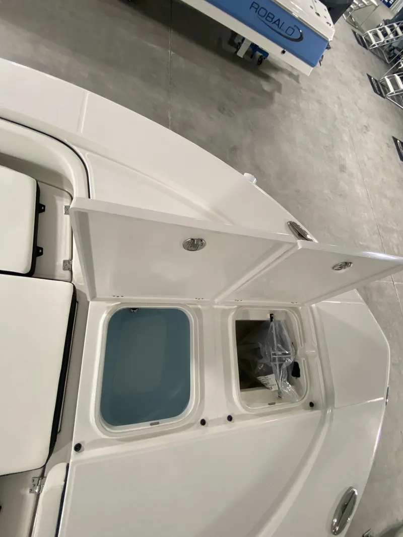 Slide: The Image of 2024 Robalo 246 Cayman boat with open storage compartments. - 14