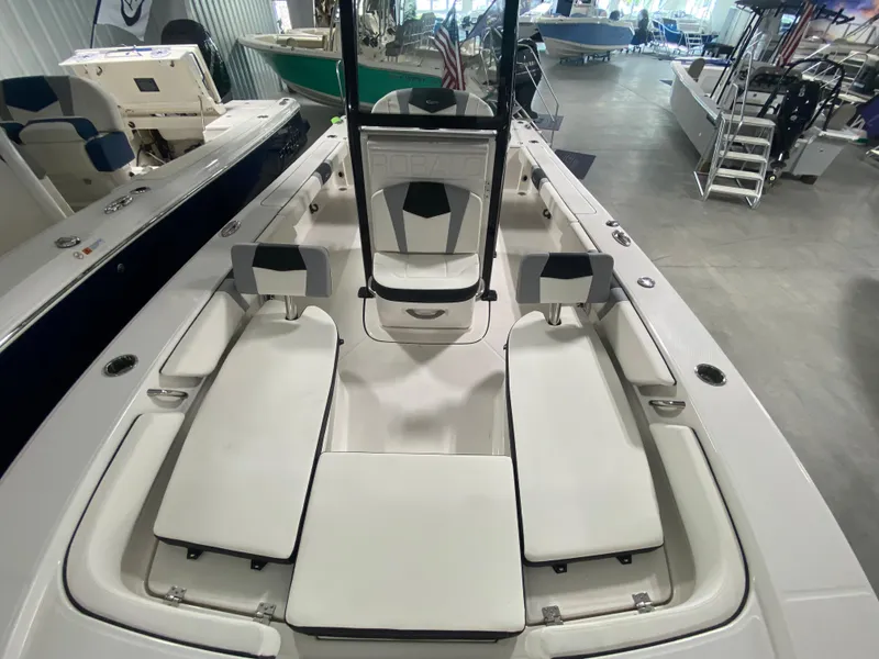 Slide: The Image of 2024 Robalo 246 Cayman boat interior with white cushioned seating. - 15