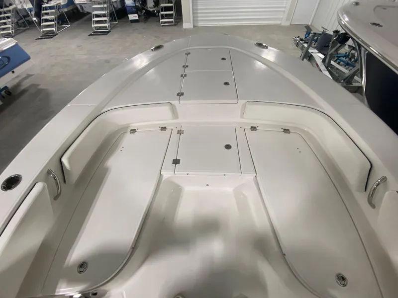 Slide: The Image of 2024 Robalo 246 Cayman boat interior with storage compartments and seating. - 16