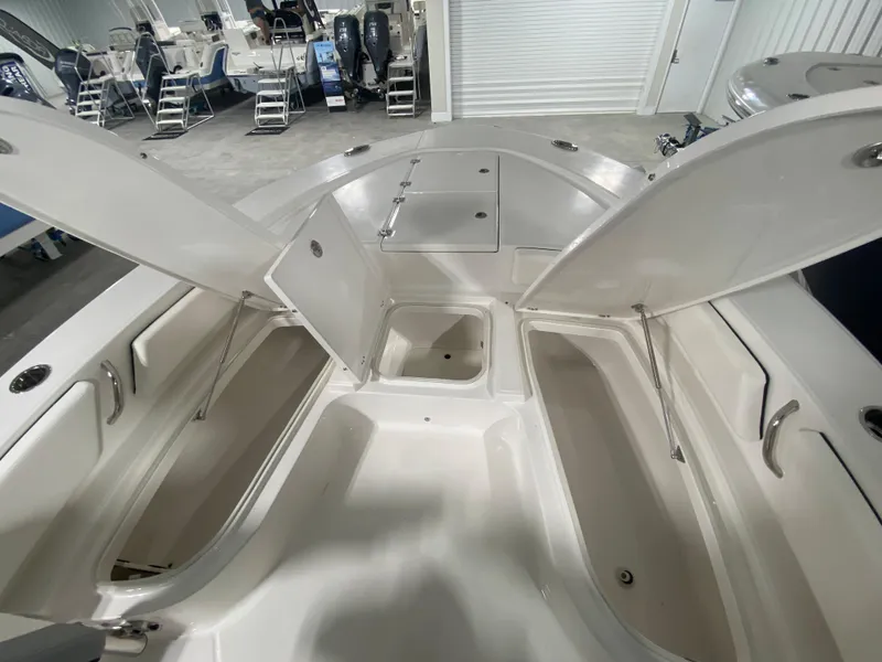 Slide: The Image of 2024 Robalo 246 Cayman boat with open storage compartments. - 17