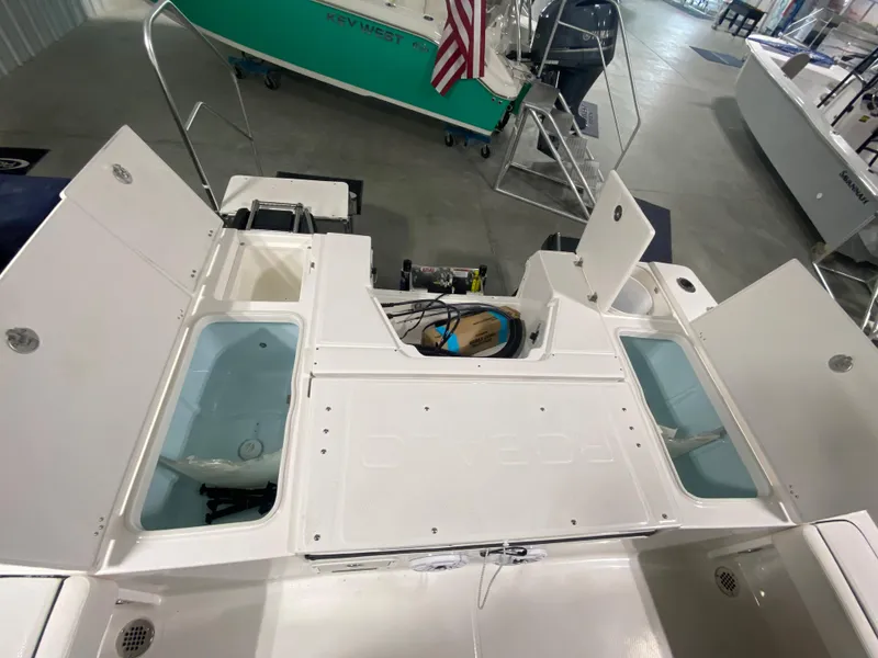 Slide: The Image of 2024 Robalo 246 Cayman boat interior with open storage compartments and livewells. - 3
