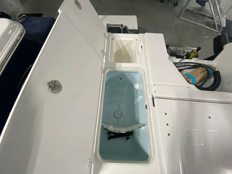 Slide: The Image of 2024 Robalo 246 Cayman boat storage compartments and livewell. - 4