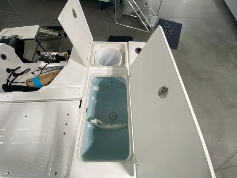 Slide: The Image of 2024 Robalo 246 Cayman boat storage compartments and livewell. - 5