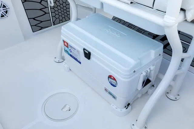 Slide: The Image of 2023 Wellcraft 222 Fisherman boat interior with cooler and seating. - 9