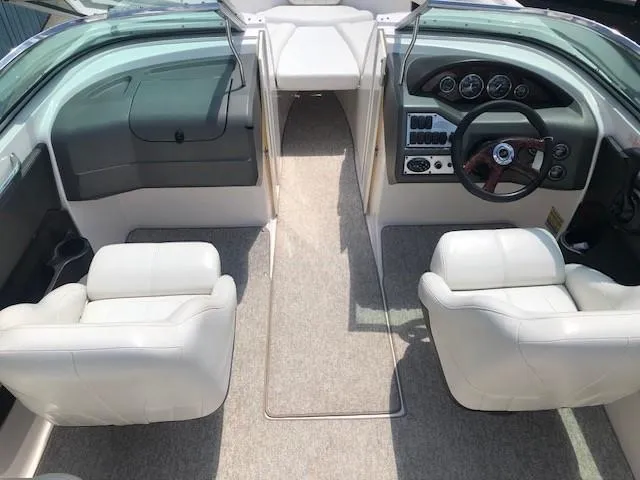 Slide: The Image of Interior of 2004 Regal 2200 Bowrider with white seats and dashboard. - 12