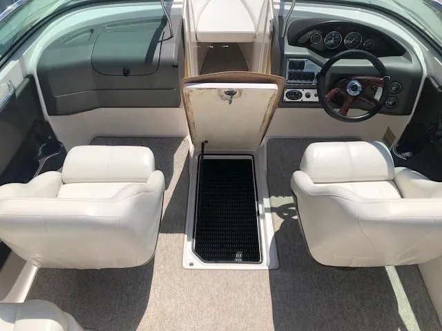 Slide: The Image of Interior of a 2004 Regal 2200 Bowrider boat with white seats. - 13
