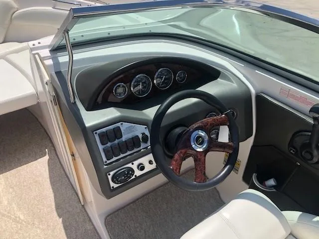 Slide: The Image of Interior view of a 2004 Regal 2200 Bowrider boat dashboard. - 14