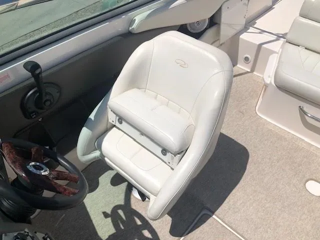 Slide: The Image of Interior of a 2004 Regal 2200 Bowrider with white seat and steering wheel. - 17