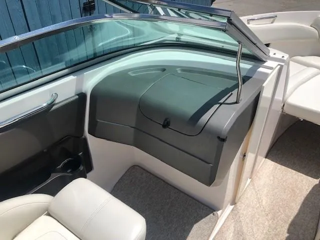 Slide: The Image of Interior of a 2004 Regal 2200 Bowrider boat with gray dashboard. - 18
