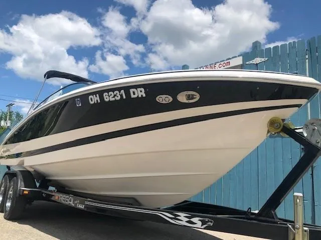 Slide: The Image of 2004 Regal 2200 Bowrider boat on trailer, blue sky. - 2