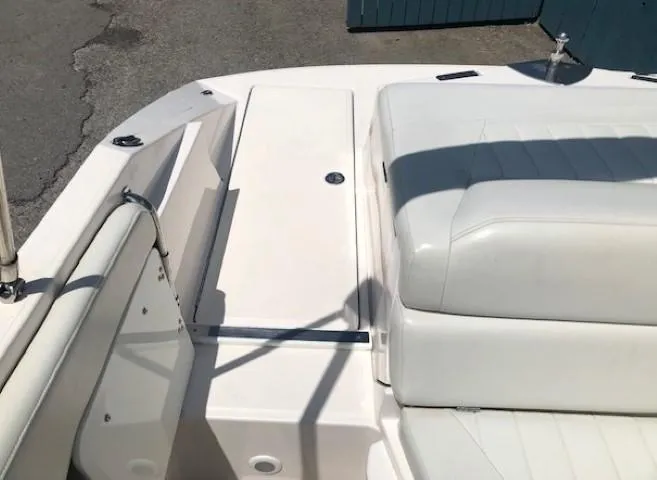 Slide: The Image of Interior of a 2004 Regal 2200 Bowrider boat with white seating. - 27