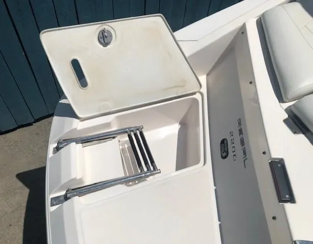 Slide: The Image of 2004 Regal 2200 Bowrider with open storage hatch and ladder. - 30