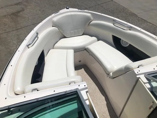 Slide: The Image of Interior view of a 2004 Regal 2200 Bowrider boat with white seating. - 7