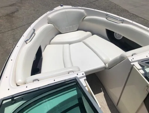 Slide: The Image of Interior view of a 2004 Regal 2200 Bowrider boat with white seating. - 8