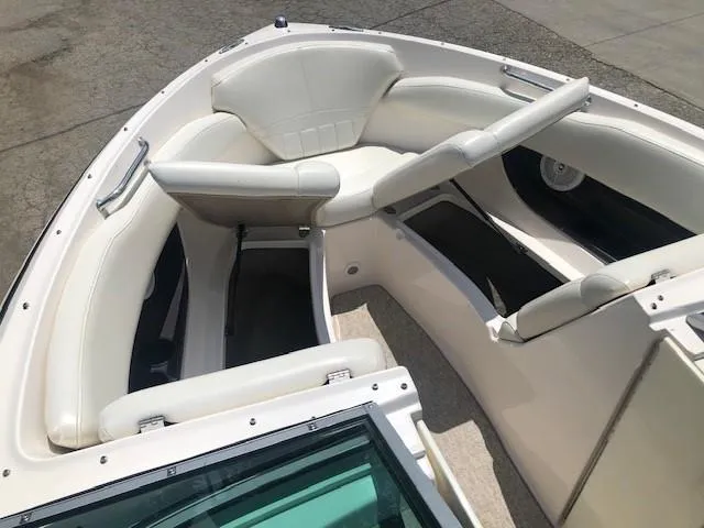 Slide: The Image of Interior view of a 2004 Regal 2200 Bowrider boat with white seating. - 9