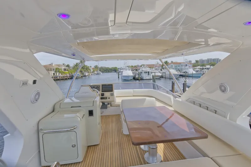 Slide: The Image of Flybridge of 2015 Azimut 64 yacht with seating area and waterfront view. - 11