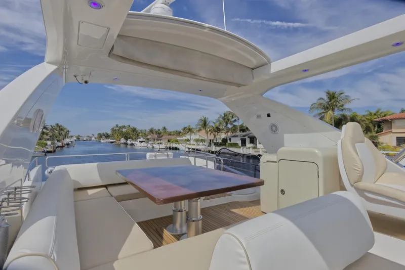 Slide: The Image of Luxurious 2015 Azimut 64 Flybridge yacht with spacious outdoor seating and scenic waterway view. - 12