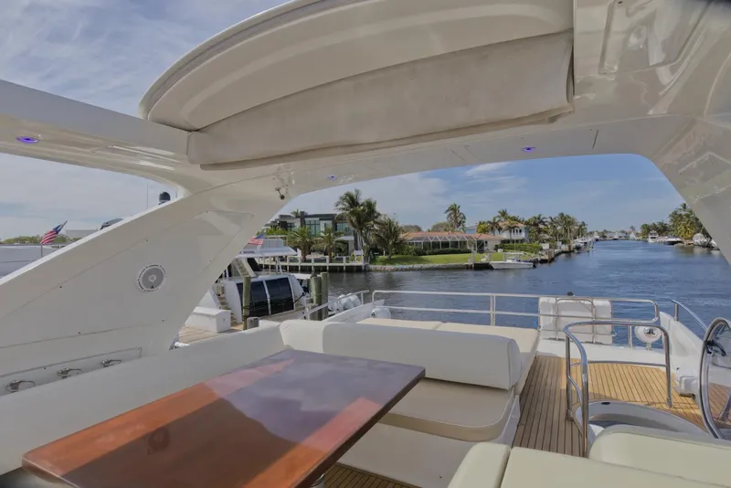 Slide: The Image of Luxurious 2015 Azimut 64 Flybridge yacht with spacious deck and scenic waterfront view. - 13