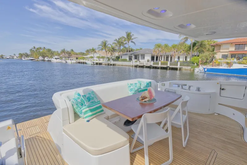 Slide: The Image of 2015 Azimut 64 Flybridge yacht deck with waterfront view and outdoor seating. - 15