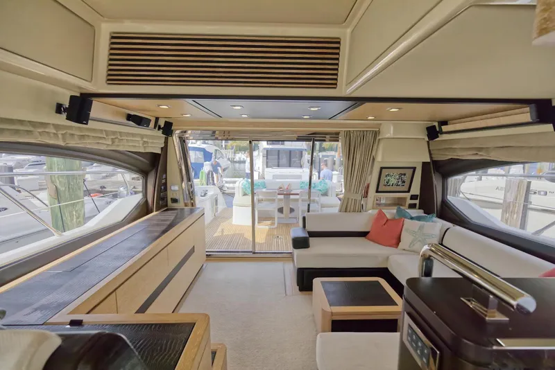 Slide: The Image of Luxurious interior of 2015 Azimut 64 Flybridge yacht with modern furnishings and large windows. - 19