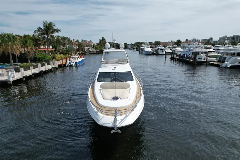 Slide: The Image of 2015 Azimut 64 Flybridge yacht cruising in a marina. - 2