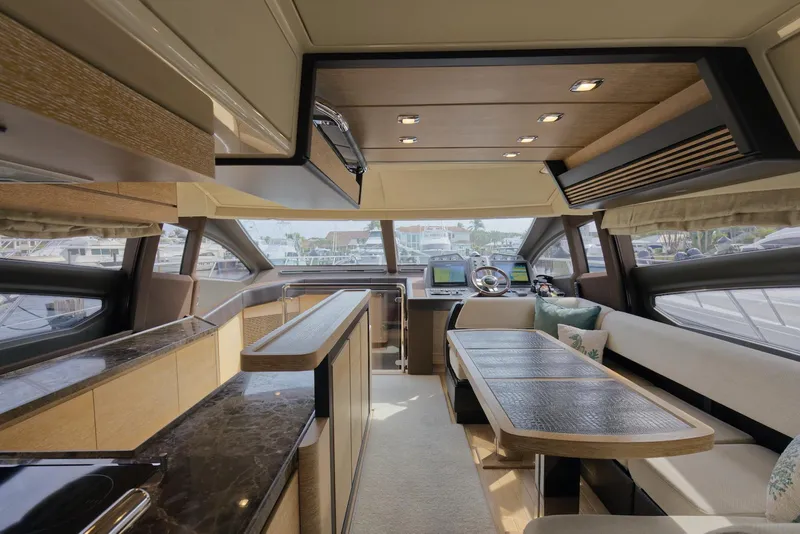 Slide: The Image of Luxurious interior of a 2015 Azimut 64 Flybridge yacht with modern furnishings and panoramic windows. - 25