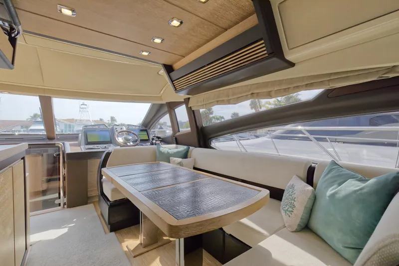 Slide: The Image of Luxurious interior of 2015 Azimut 64 Flybridge yacht with modern seating and dining area. - 26
