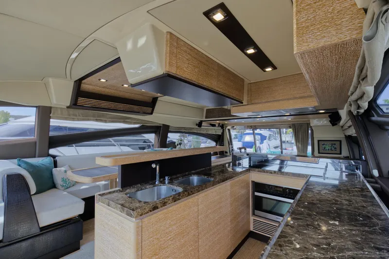 Slide: The Image of Luxurious interior of 2015 Azimut 64 Flybridge yacht with modern kitchen and seating area. - 28