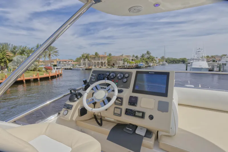 Slide: The Image of Helm of 2015 Azimut 64 Flybridge yacht with waterfront view. - 9