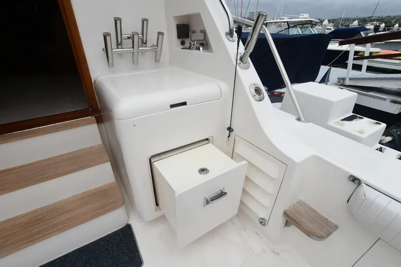 Slide: The Image of 1988 Bertram 54 Convertible yacht interior with storage compartment and steps. - 13