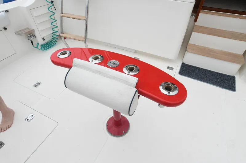 Slide: The Image of Red fishing rod holder on 1988 Bertram 54 Convertible yacht deck. - 15