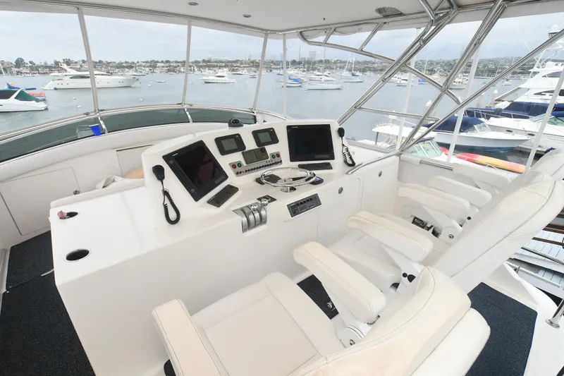 Slide: The Image of 1988 Bertram 54 Convertible yacht helm with modern navigation equipment and luxurious seating. - 17