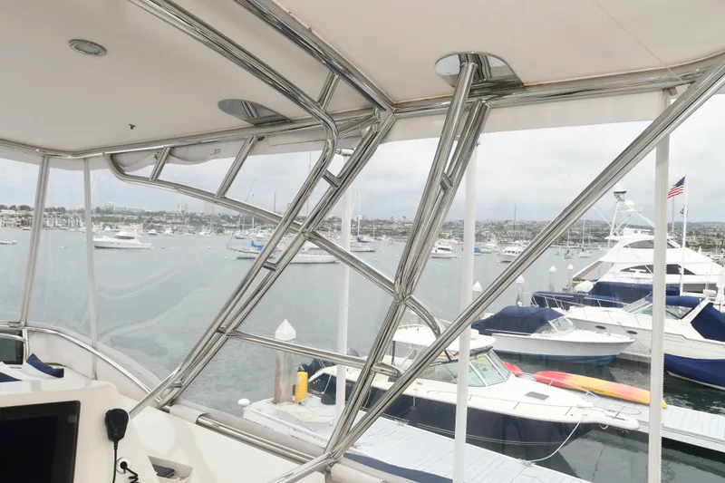 Slide: The Image of View from a 1988 Bertram 54 Convertible yacht overlooking a marina with boats. - 21