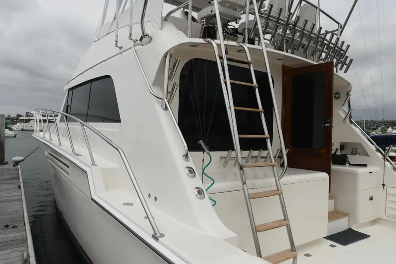Slide: The Image of 1988 Bertram 54 Convertible yacht docked, rear view with ladder and open door. - 23