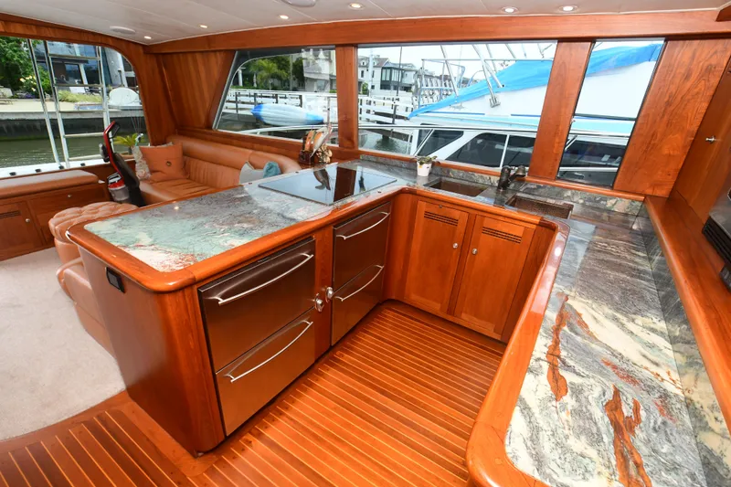 Slide: The Image of Luxurious kitchen area in a 1988 Bertram 54 Convertible yacht with marble countertops. - 28