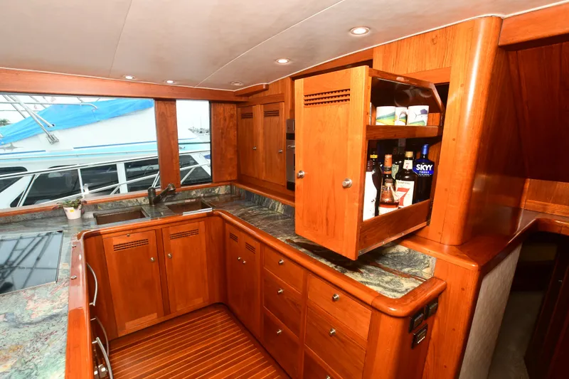 Slide: The Image of 1988 Bertram 54 Convertible yacht kitchen with wooden cabinets and granite countertops. - 31